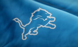 NFL team Detroit Lions logo on waving jersey fabric. Editorial 3D rendering